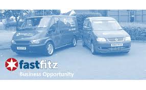 two fast fitz vans parked side by side with fast fitz sign writing on them