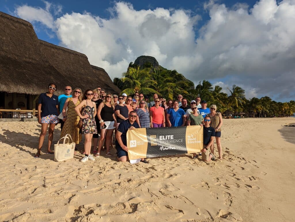 travel franchise consultants gathered on a beach together