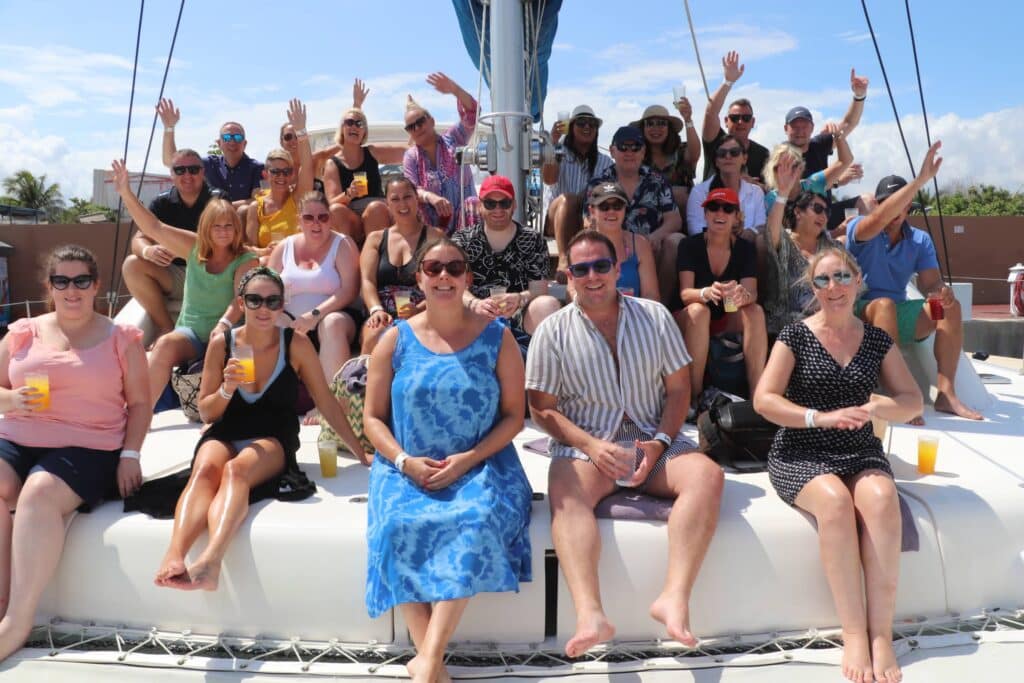 The travel franchise franchisees sat on board a boat in the sun