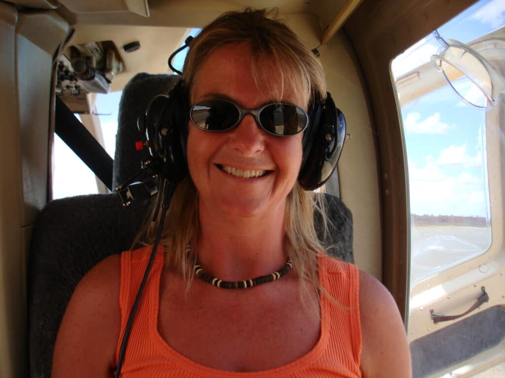 In a helicopter flyingover Uluru Rock Australia