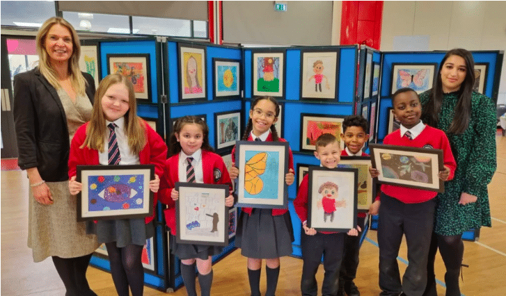 teacher and students at art exhibition