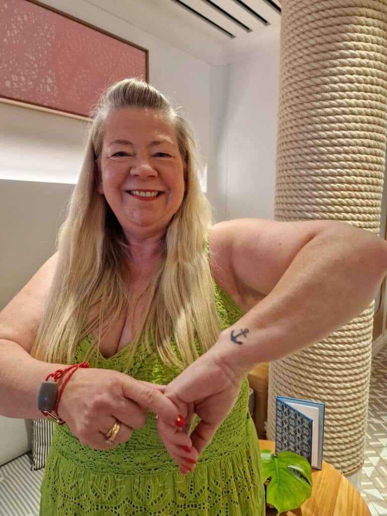 franchisee Gaynor with an anchor tattoo on her arm